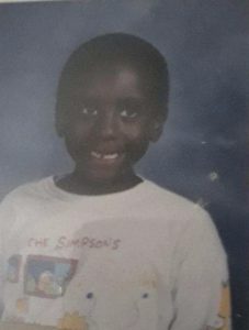 young boy smiling for his school picture