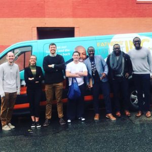 group of man standing against a van posing